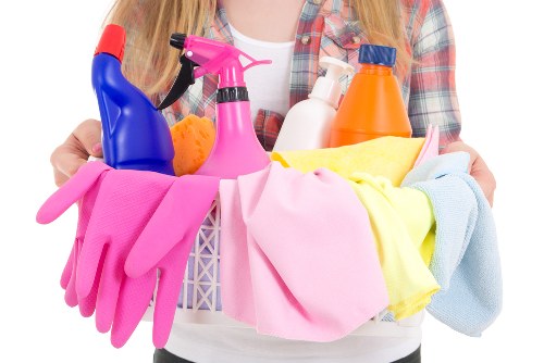 Domestic cleaner working in a Stockwell flat living room
